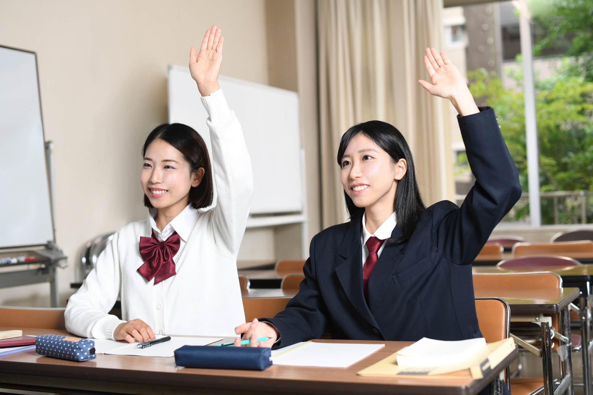 授業中に元気に挙手する女子学生