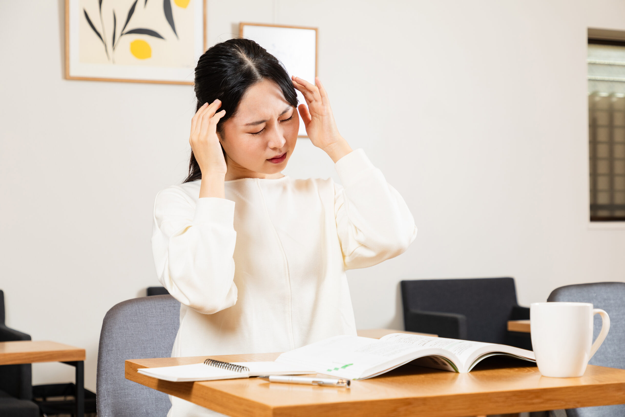 勉強中に頭を抱える女性