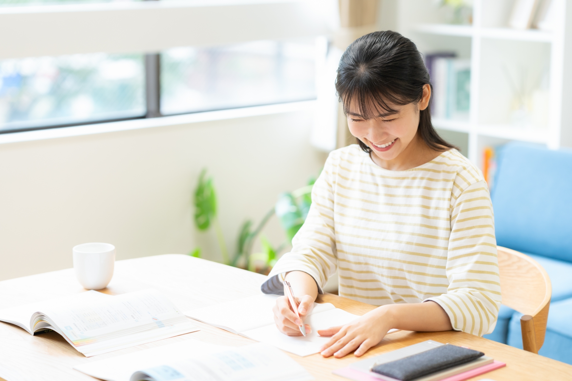 リビングで勉強をする大学生の女性